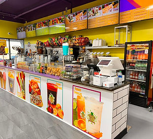 Paleteria El Chavo service counter with colorful menu boards and fresh paletas on display
